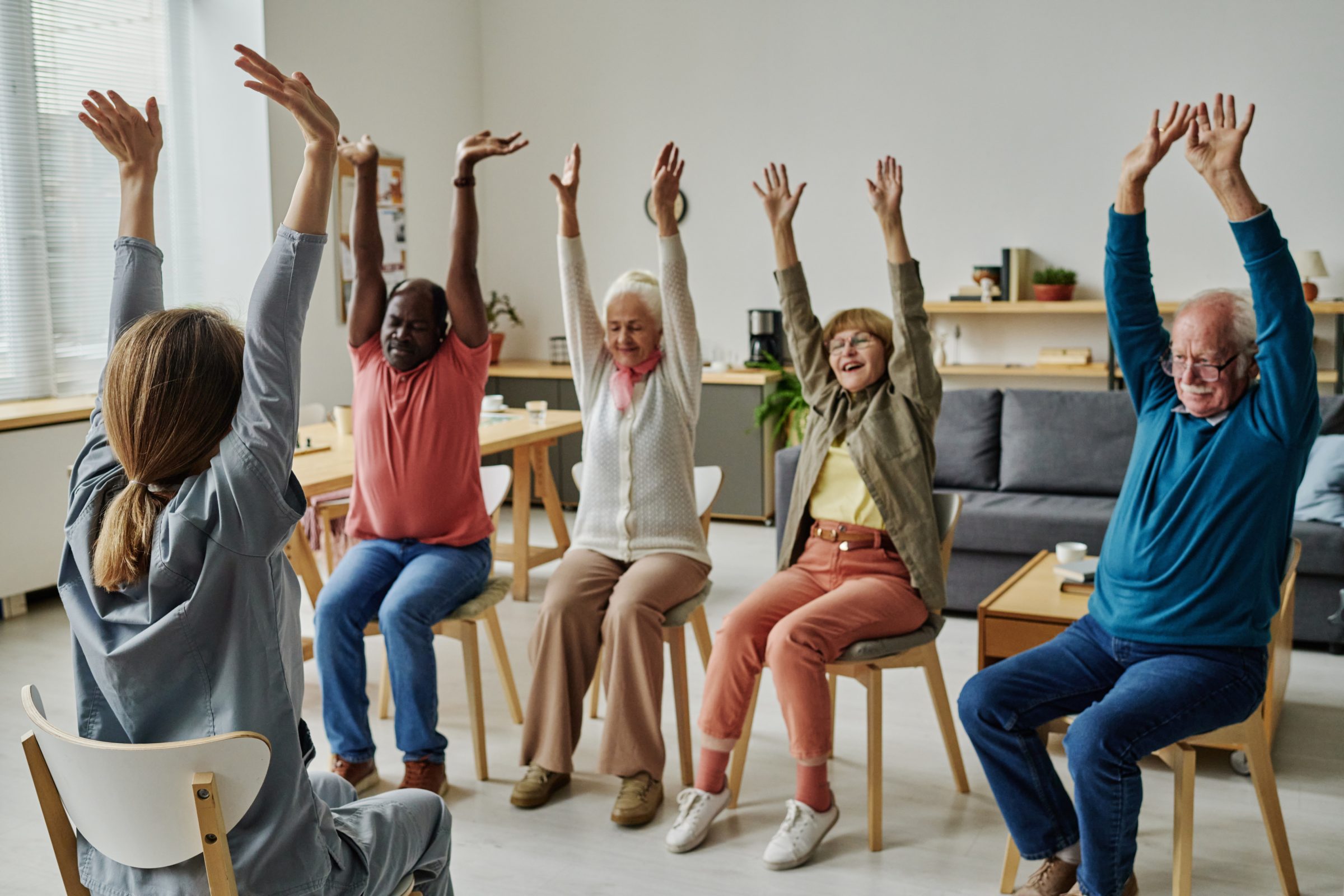 Older adults stretching in a seated exercise class