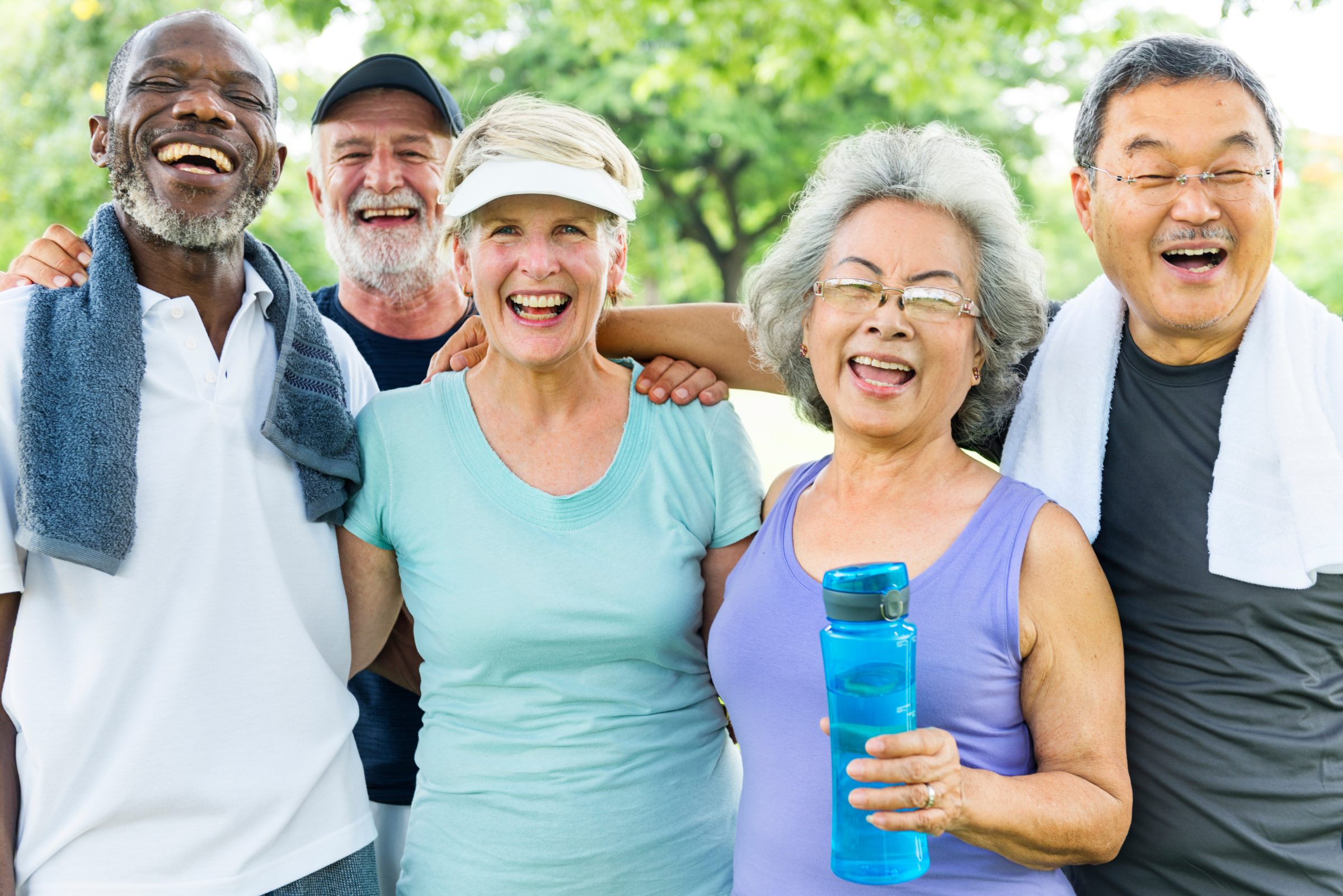 A group of older friends laughing together after exercising outdoors